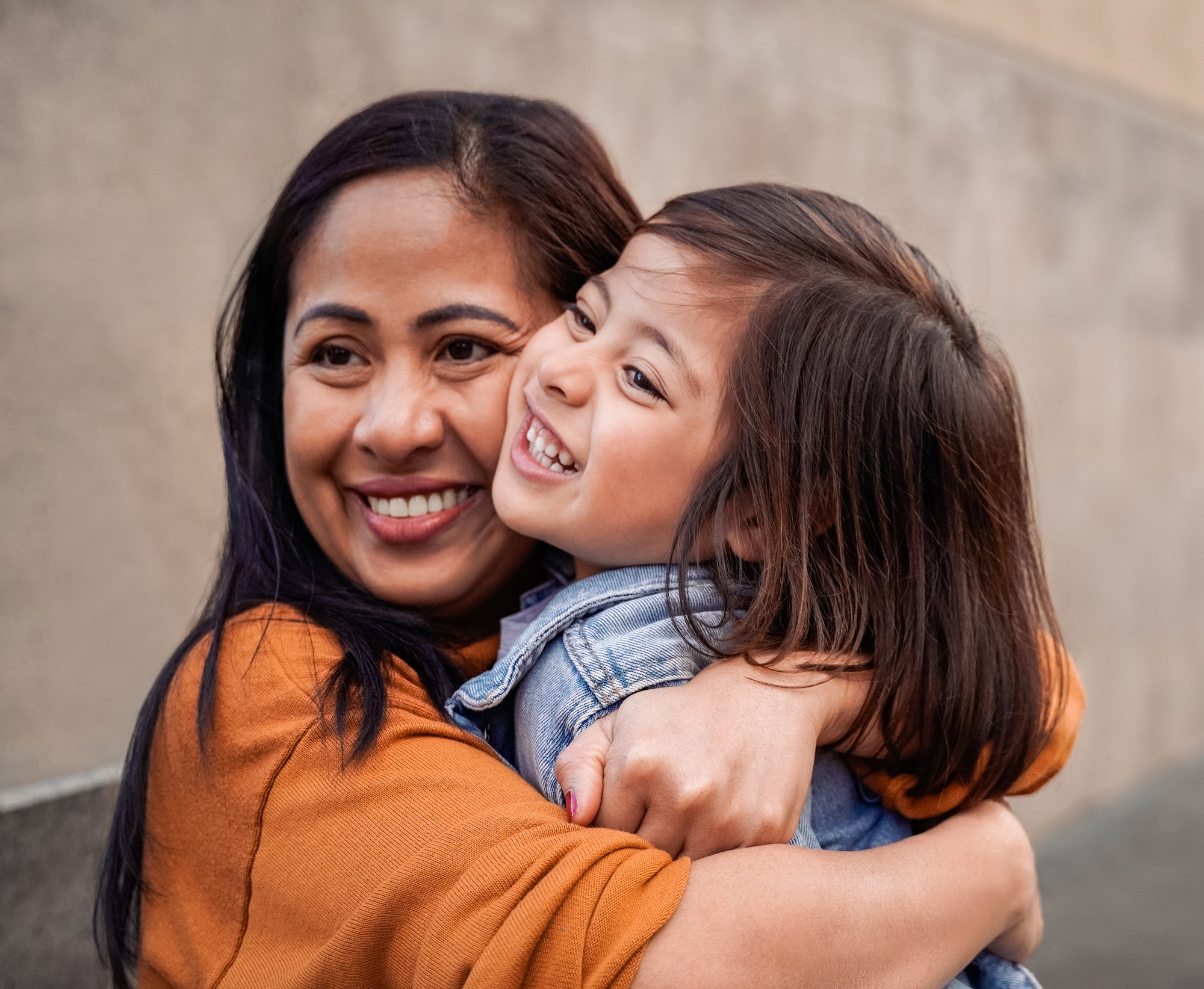 Happy Asian mother and daughter having fun together outdoor - Focus on mom hands